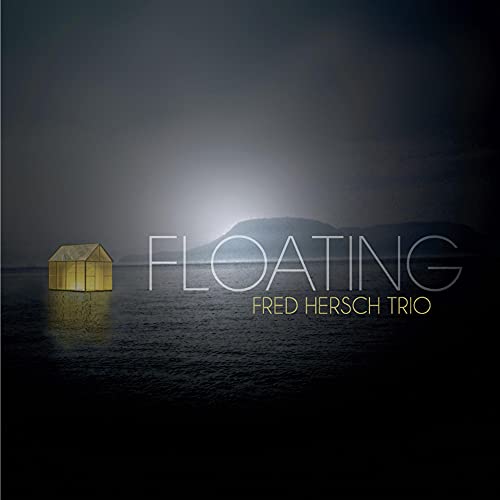 Album cover for Fred Hersch Trio’s “Floating” featuring a small illuminated house on water.