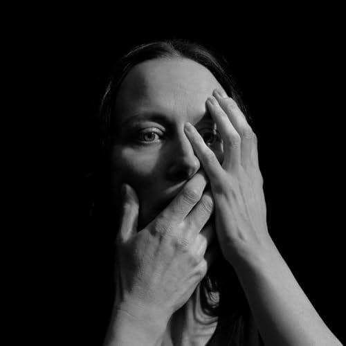 Black and white portrait of a woman partially covering her face.