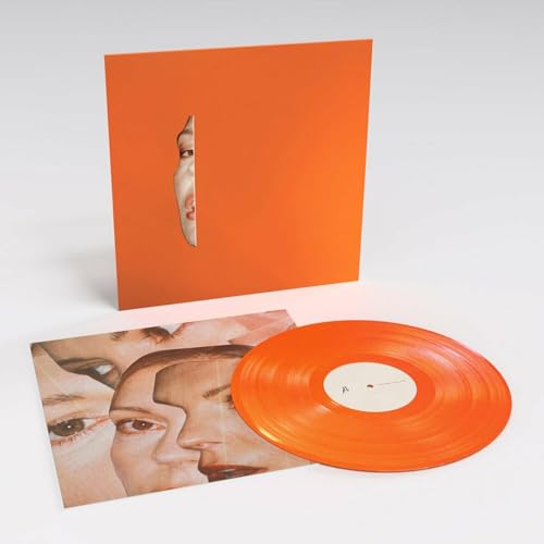 Orange vinyl record and sleeve with a cut-out face portrait.
