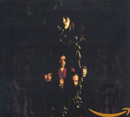 Dark album cover featuring three figures and tangled branches.