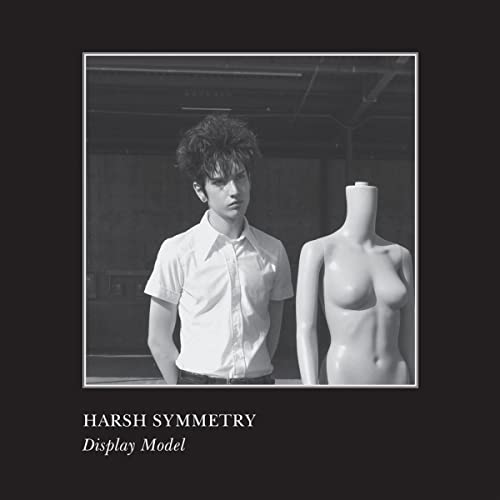 Black and white photo of a man and mannequin, album cover.