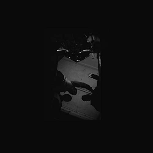Black and white album cover with shadowy figures around a record player.