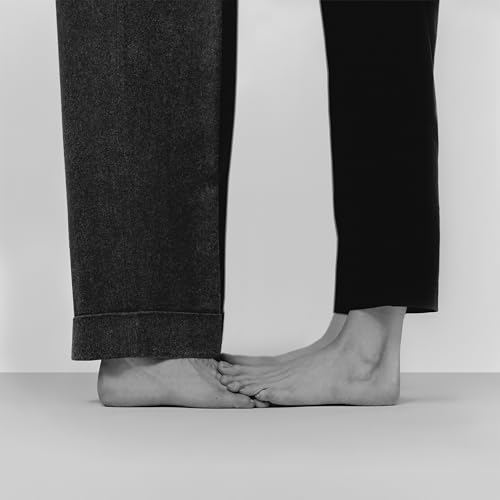 Black and white photo of two bare feet touching, vinyl record artwork.