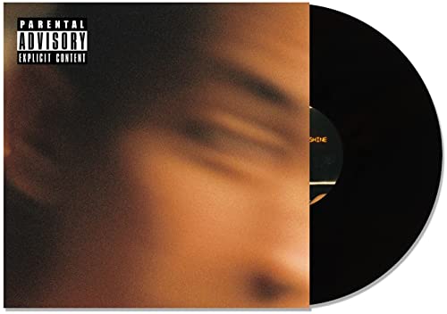 Vinyl record with blurred face and parental advisory label.