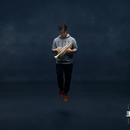 Man playing trumpet, floating against a dark, smoky blue background.