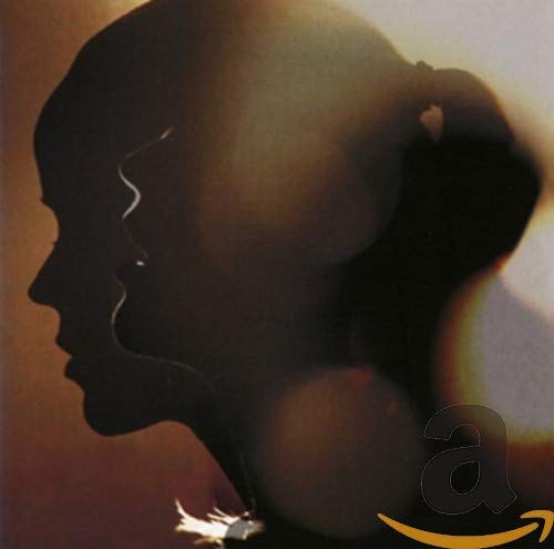 A silhouette of two faces in profile facing each other against a warm background.