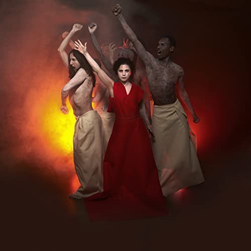 Group of figures with raised arms against a fiery, blurred background.