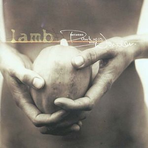 Hands cradling a peach with album title "Lamb - Between Darkness And Wonder".
