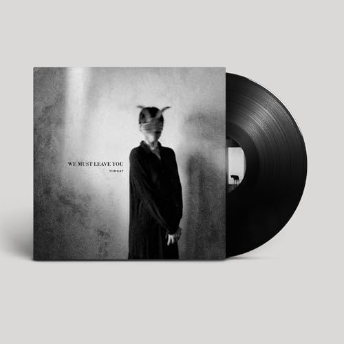 Black vinyl record with album cover featuring a blurred figure.