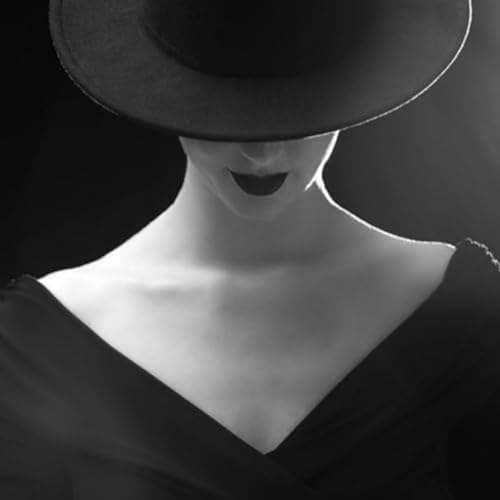 Black and white portrait of a person wearing a wide-brimmed hat.