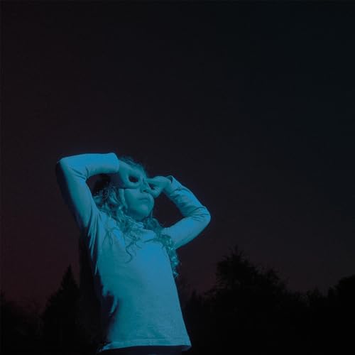 Child looking through hands as a frame, blue and purple lighting.