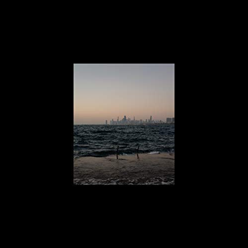 City skyline viewed across dark water at dusk, album cover.
