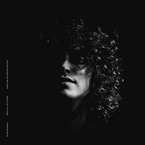 Black and white portrait of a person with curly hair, album cover.