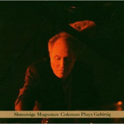 CD cover: portrait of a man in shadow, dark red tones.