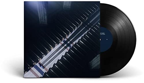 Vinyl record and album cover featuring a piano keyboard image.