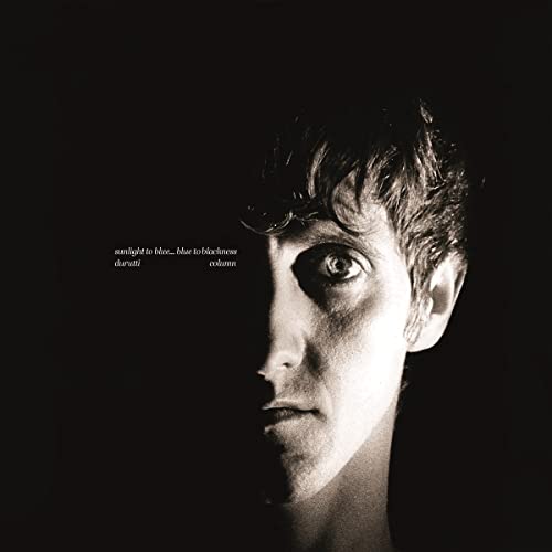 Black and white album cover featuring a man’s shadowed face.