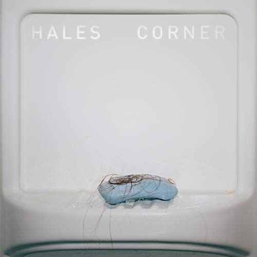 White CD case with a small, blue, abstract object centered on it.