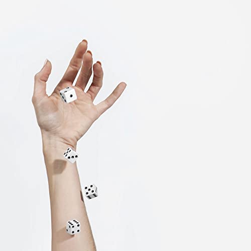 Hand releasing white dice into the air against a white background.