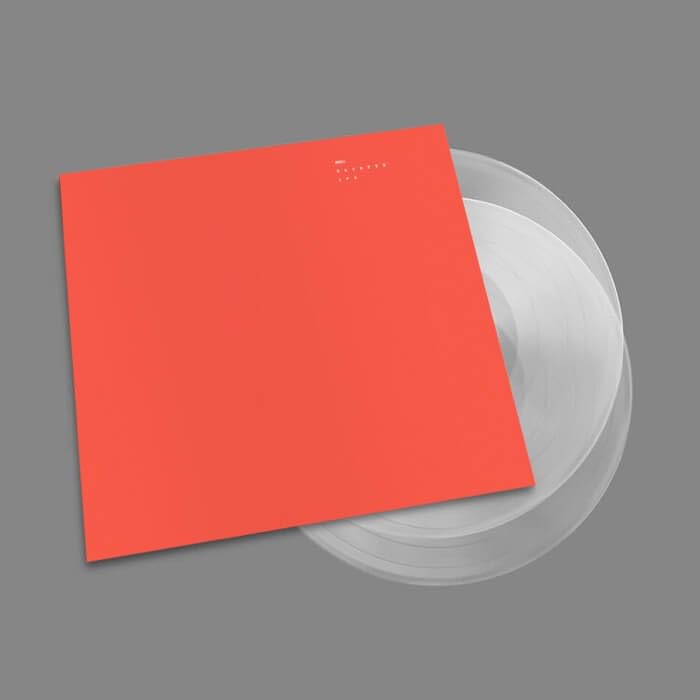 Red album cover with white text, overlaid on two clear vinyl records.