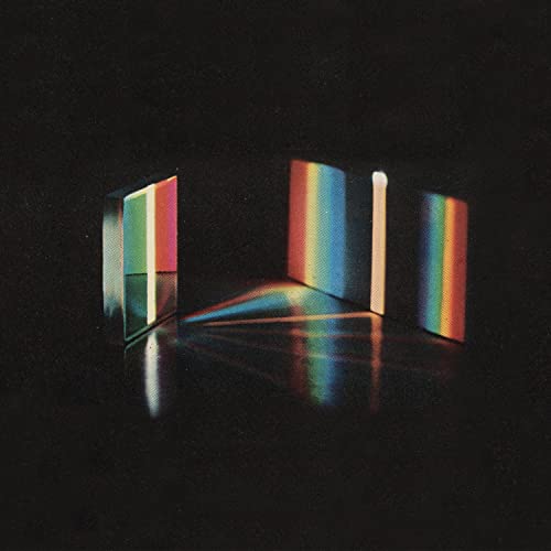 Dark album cover with colorful light and shadow in a room.