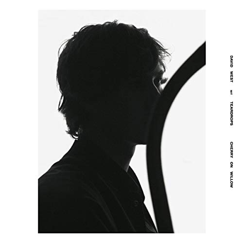 Black and white album cover featuring a profile of a man’s face.
