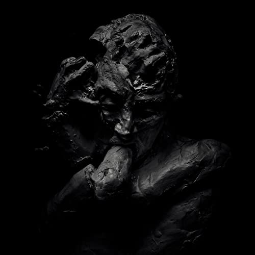 A dark, textured sculpture of a human figure with a distressed, crumbling face.