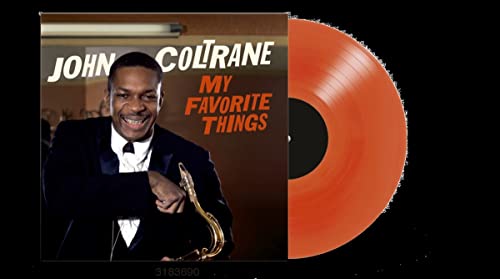 Vinyl record and cover featuring John Coltrane with a saxophone and orange disc.