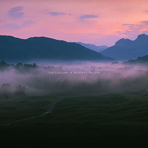 Album cover: misty mountains under a pink and purple sky.