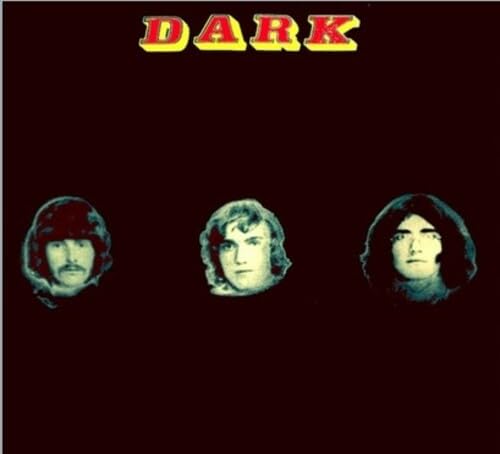 Album cover for “Dark - In The Sky” featuring three portrait heads.