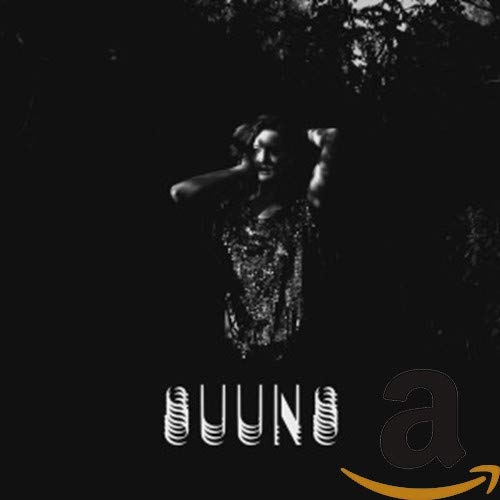 Black and white album cover for Suuns’ “Zeroes QC” with a figure and text.