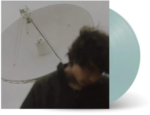Vinyl record with album art featuring a person and satellite dish.