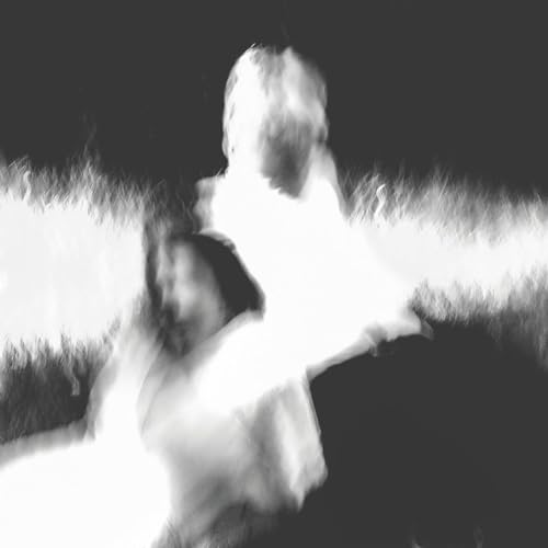 Black and white abstract image of blurred figures in grass.