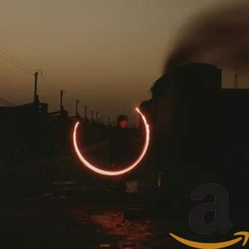 CD cover with a blurred industrial landscape and glowing arc.