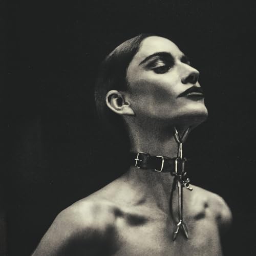 Black and white portrait of Niia with a metal collar and tool.