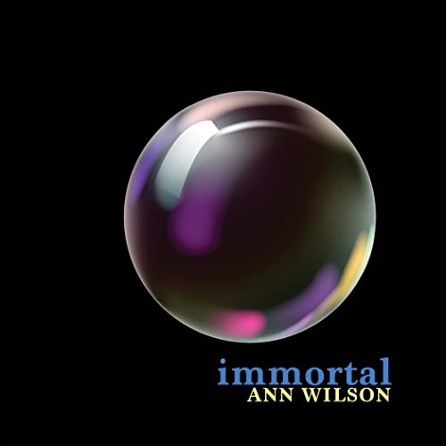 A glossy, iridescent bubble floats against a black background above the text Immortal Ann Wilson.
