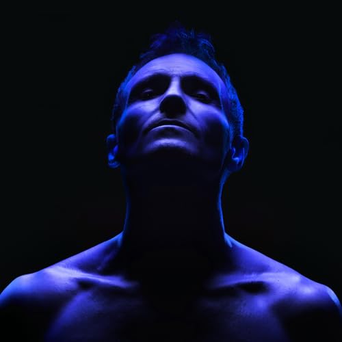 Marti Pellow portrait, looking up, bathed in cool blue light.
