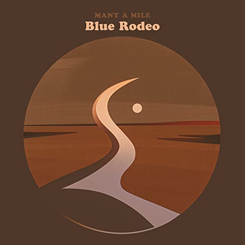 Album cover for Blue Rodeo’s “Many A Mile” featuring a winding road.