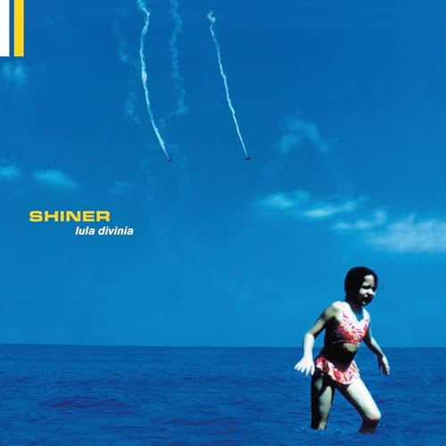 Album cover: girl in ocean, jets stream across blue sky.