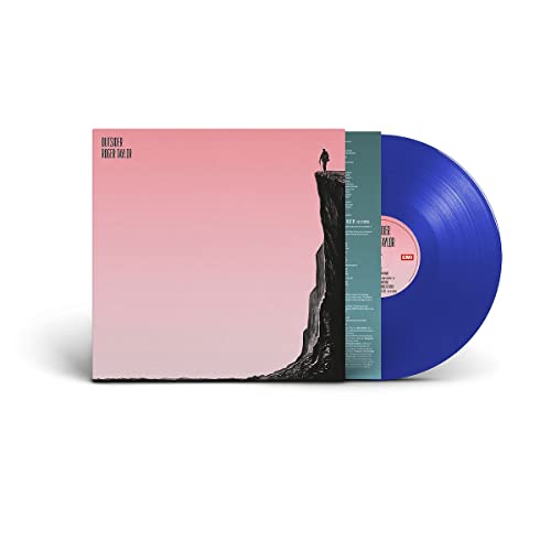 Vinyl record and pink album cover with a person on a cliff edge.