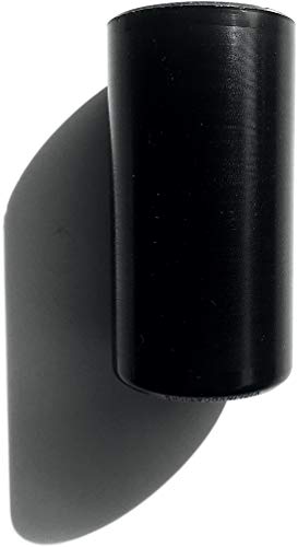 Black vinyl record standing vertically, casting a long shadow.