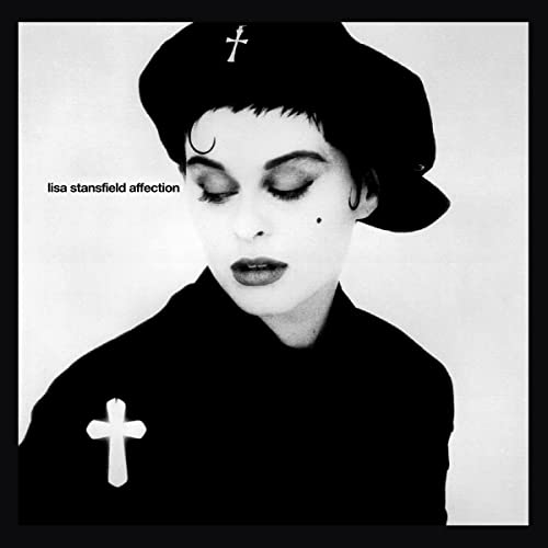Black and white album cover featuring Lisa Stansfield wearing a beret and cross pin.