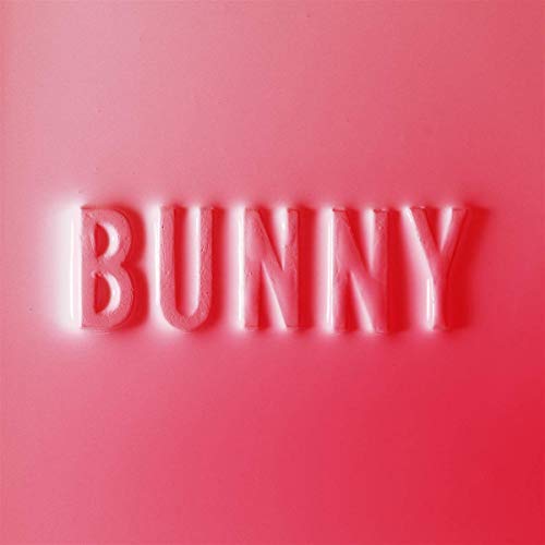 The word BUNNY in embossed, raised lettering on a solid pink background.