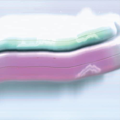 Close-up of a vinyl record in a pink and teal sleeve.