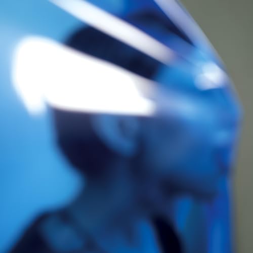 Blurred blue portrait of a person, likely a CD album cover.