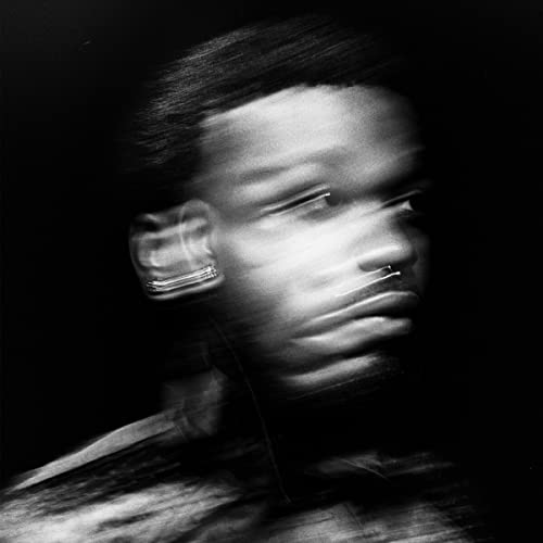 Black and white portrait of Cakes Da Killa with blurred features.