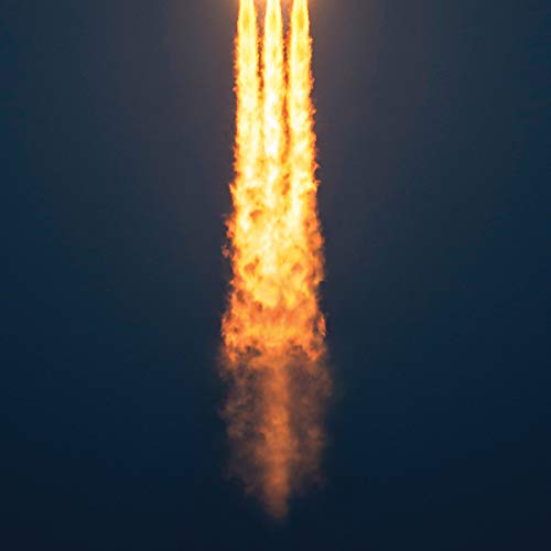 Bright orange flames rising vertically against a dark blue sky.