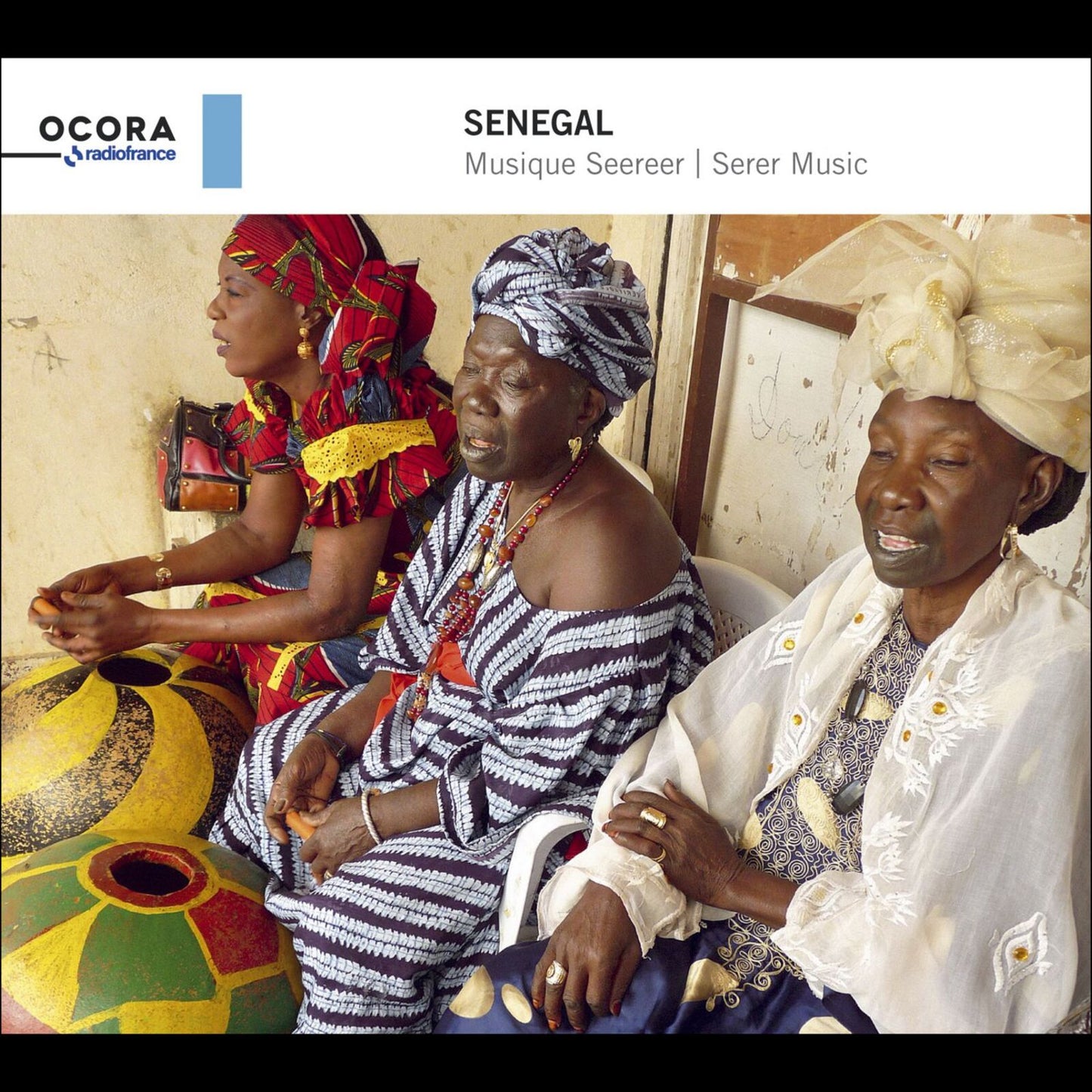 Three Senegalese musicians in traditional clothing, CD cover art.