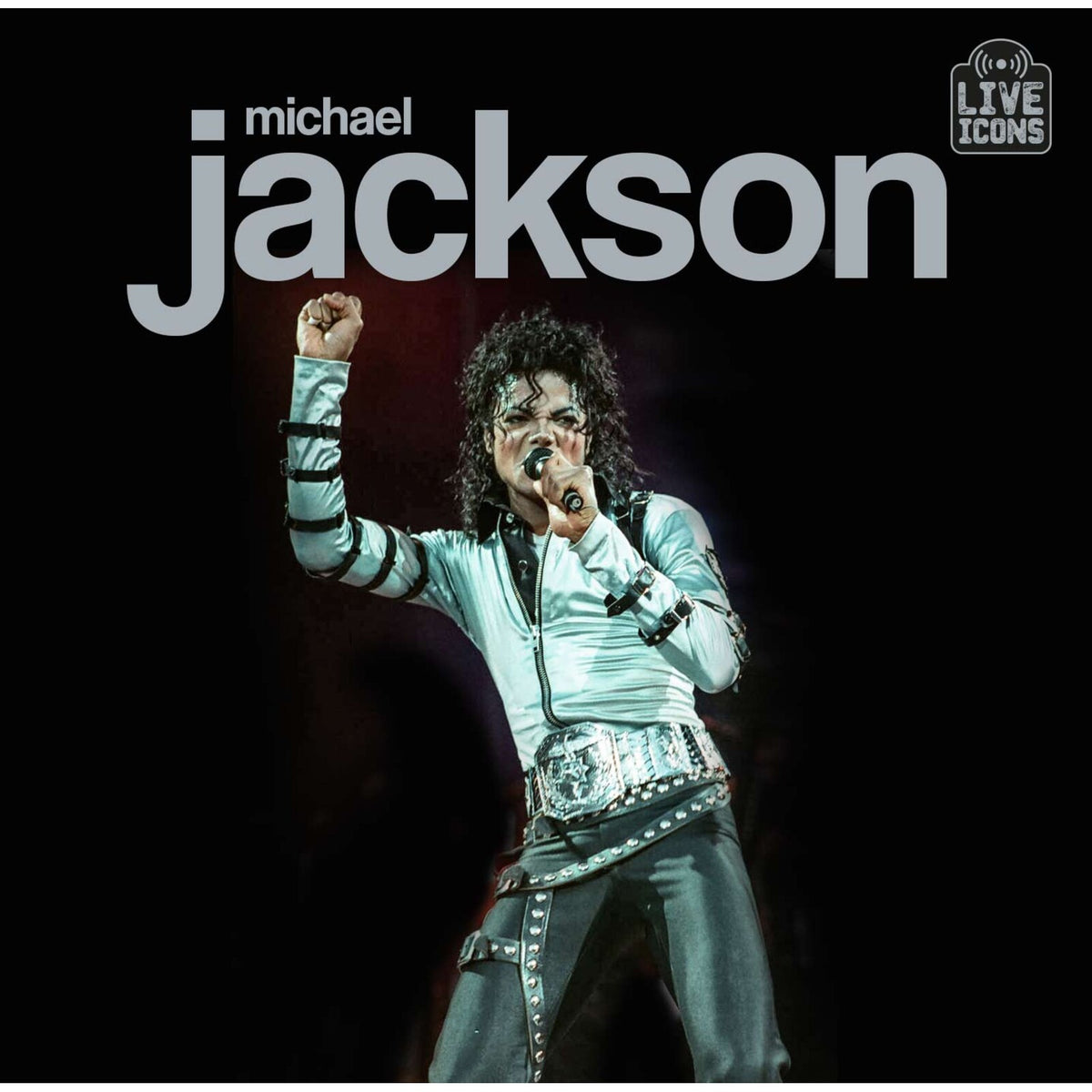 Michael Jackson in a black jacket performing onstage, album cover.