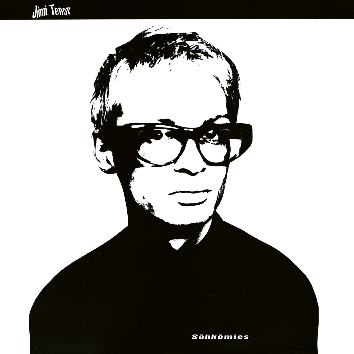 Black and white portrait of a man wearing thick-rimmed glasses.