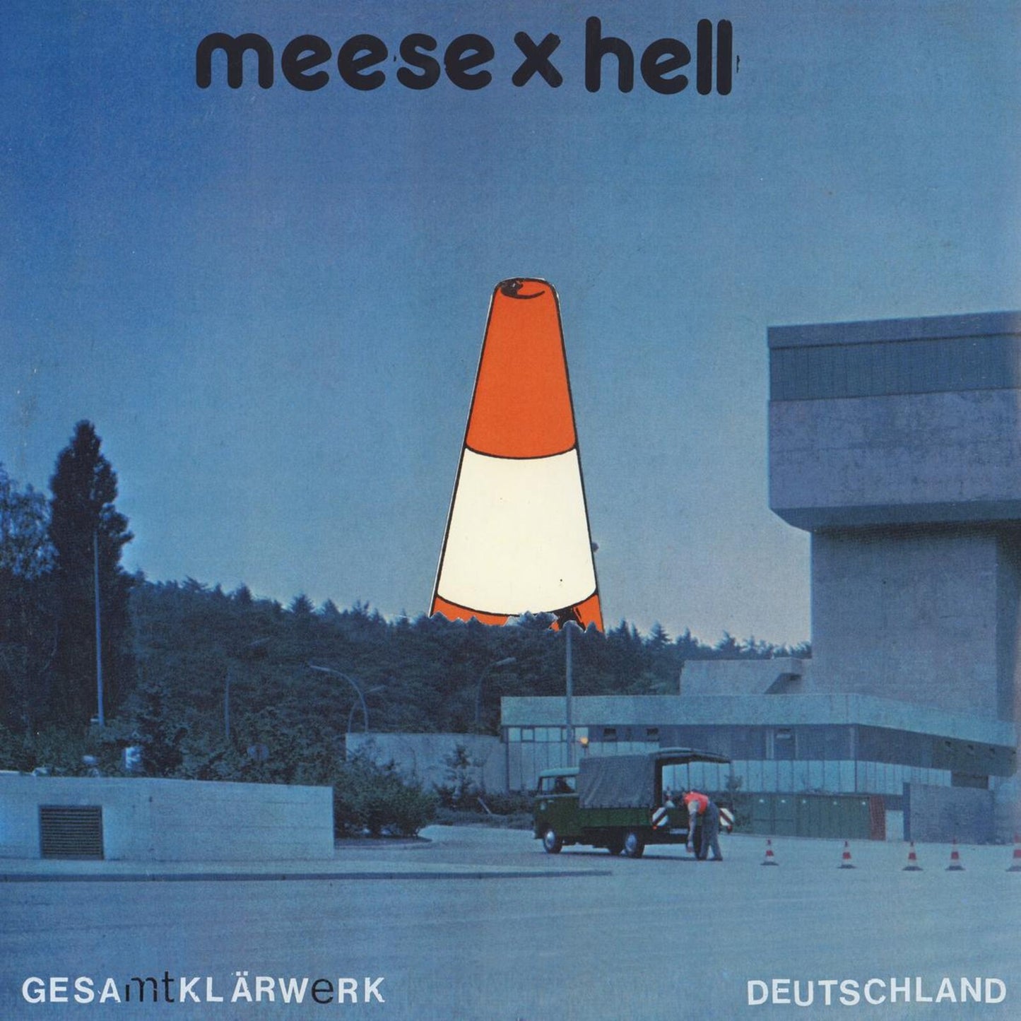 Album cover: orange traffic cone over a concrete building complex.